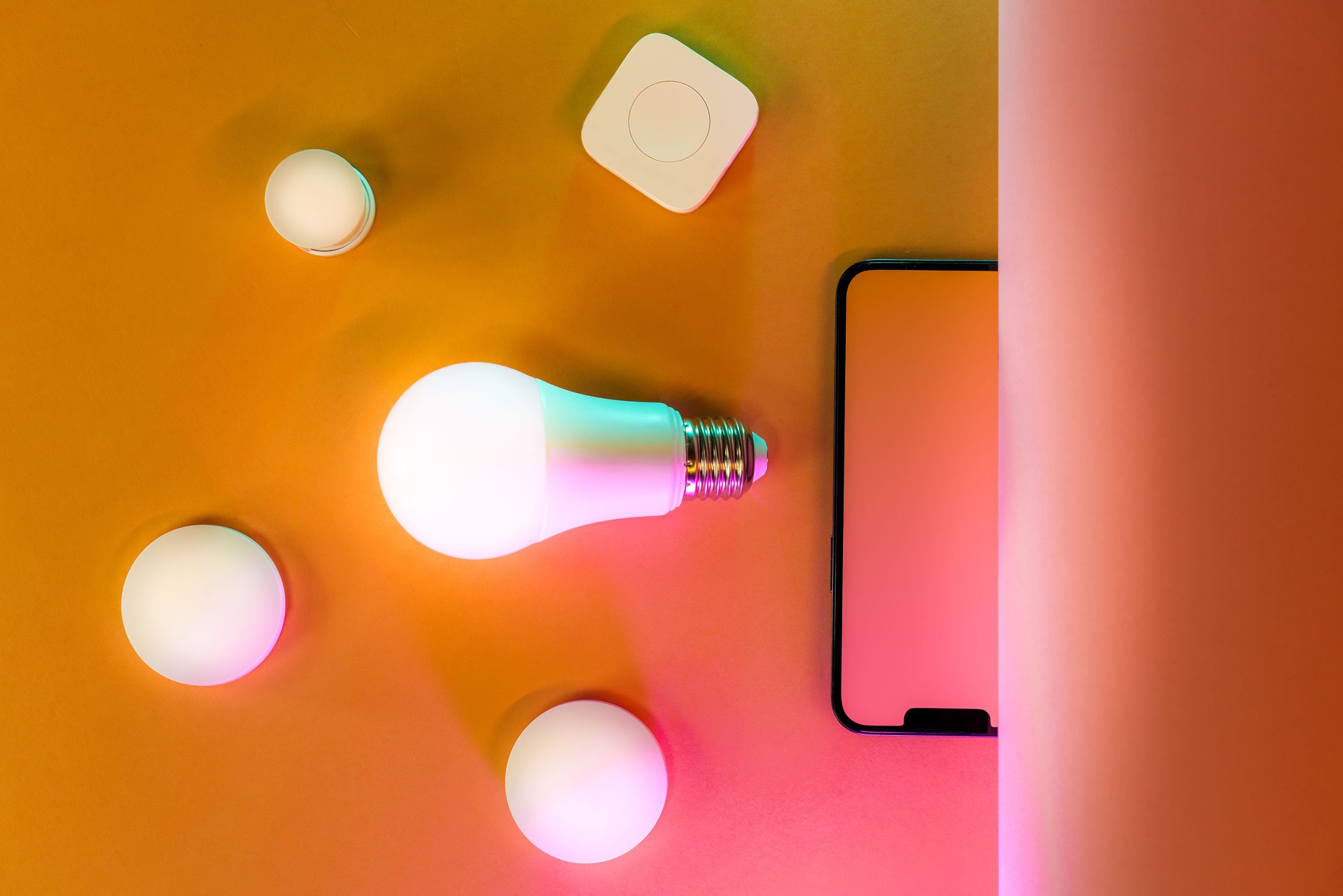 Ampoule LED connectée sur fond orange lumineux